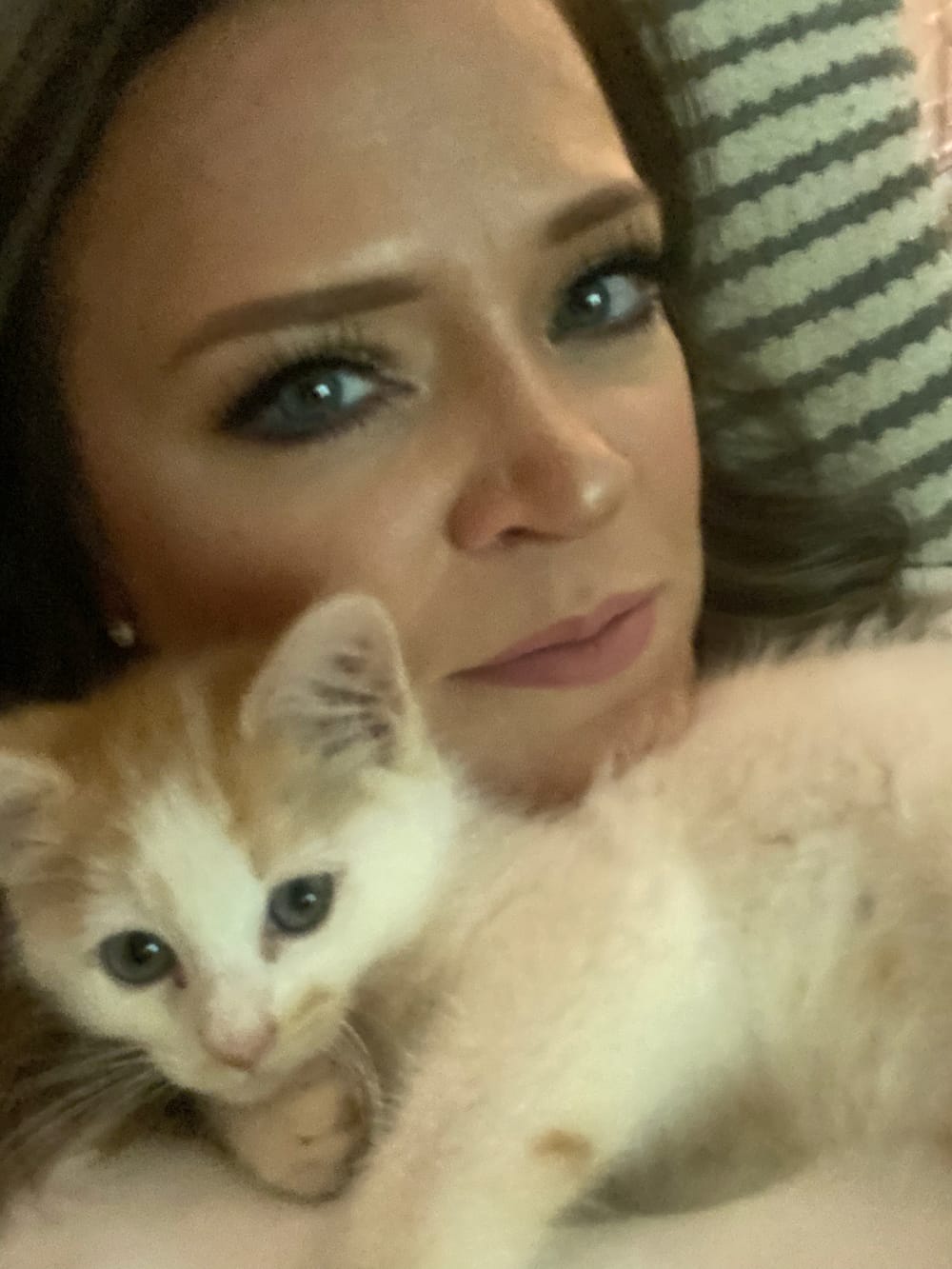 Jackie cuddling an orange and white kitten